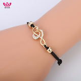CZ Studded Treble Clef on Contrasting Black Rope Bracelet